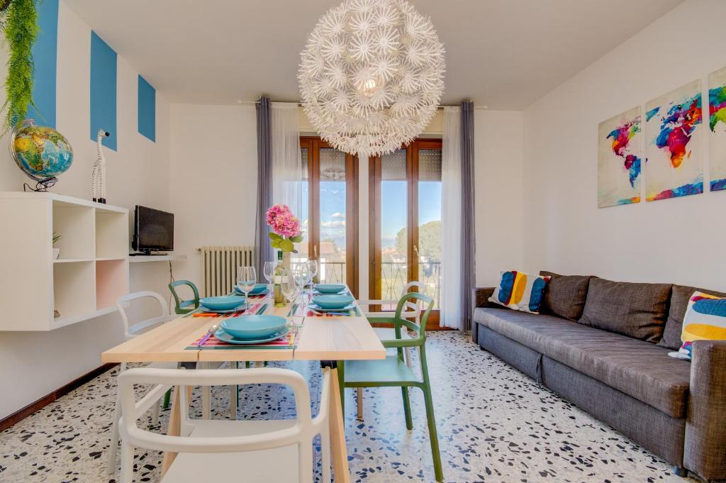 a living room with a table and a couch at Isa Sirmione Apartments in Sirmione