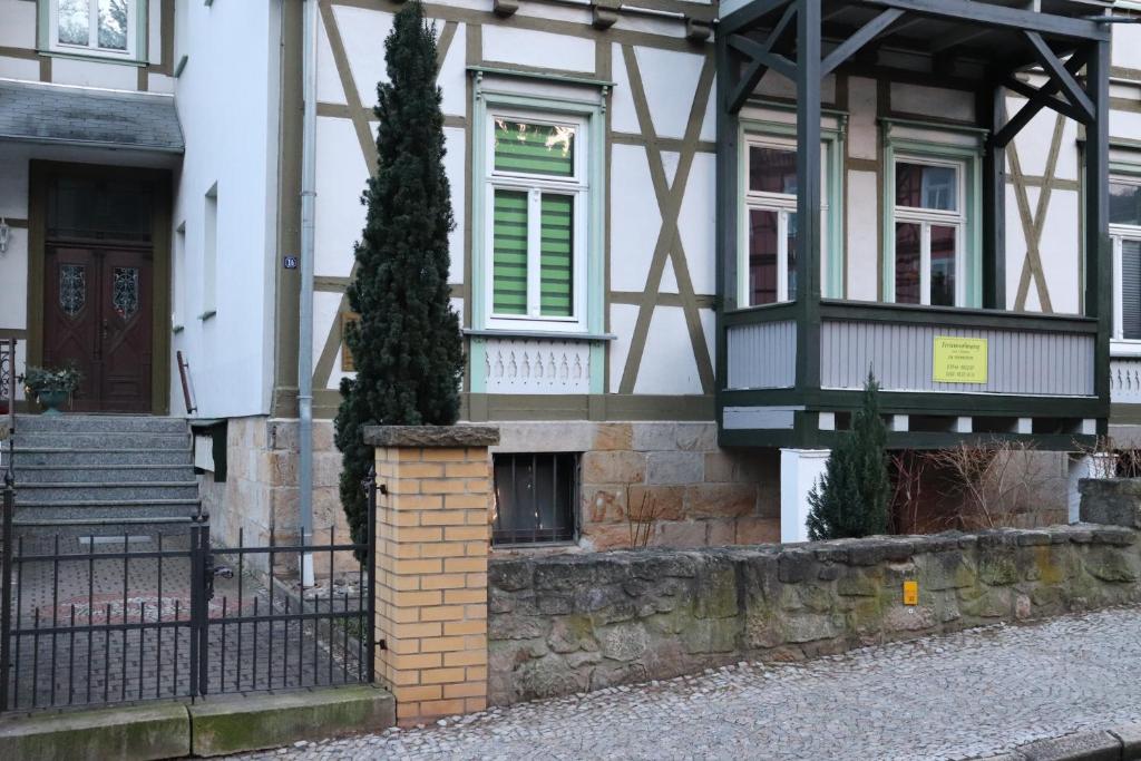 dom z drzewem przed nim w obiekcie Ferienwohnung Berthold WG 3 w mieście Blankenburg