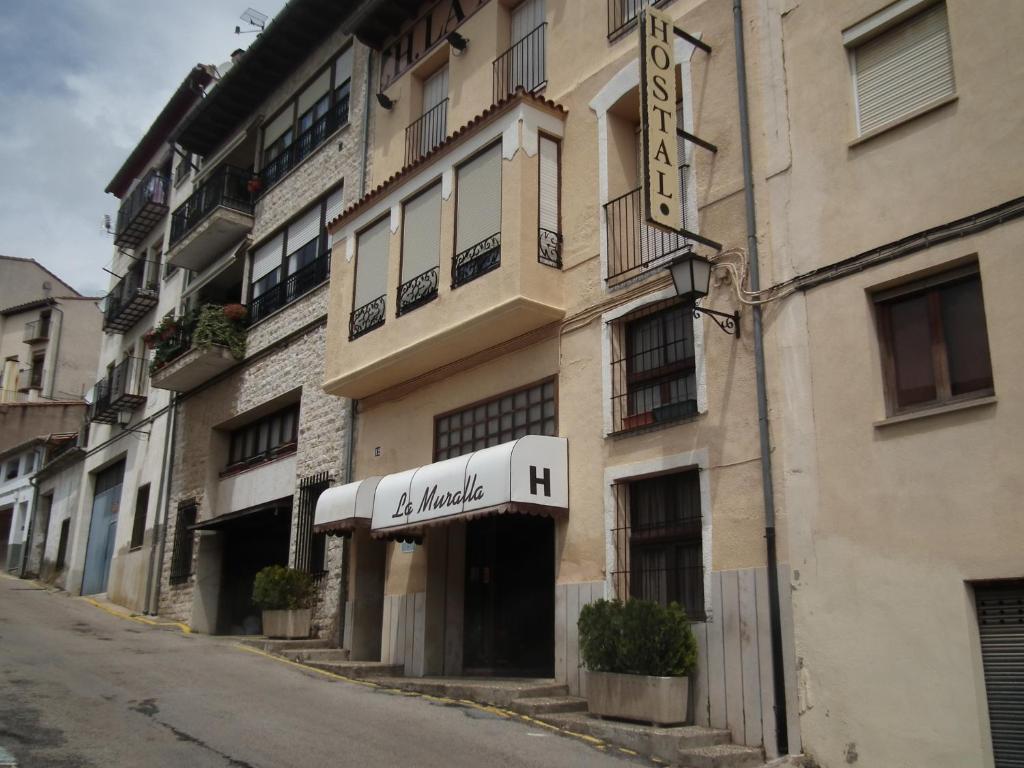 a building with a sign for a hotel at Hostal La Muralla in Morella