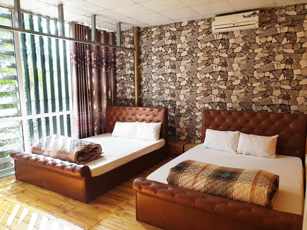 Postel nebo postele na pokoji v ubytování Long Hotel and motobike rental
