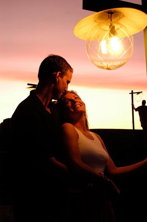a man and a woman sitting next to each other at Young Island Resort in Kingstown