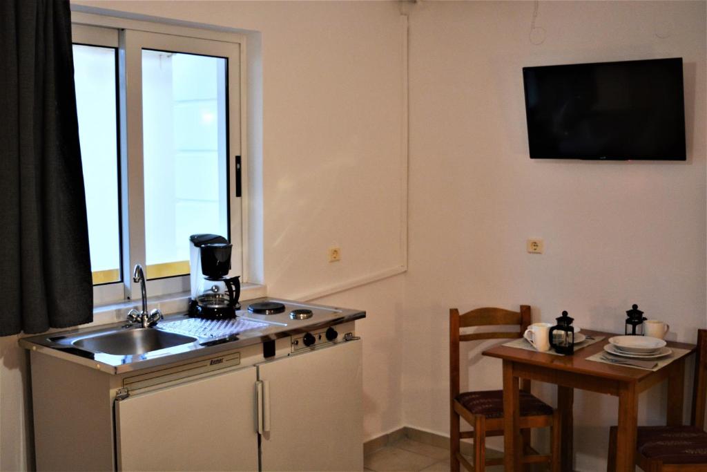 A kitchen or kitchenette at Raph's Studios-Apts By The Sea