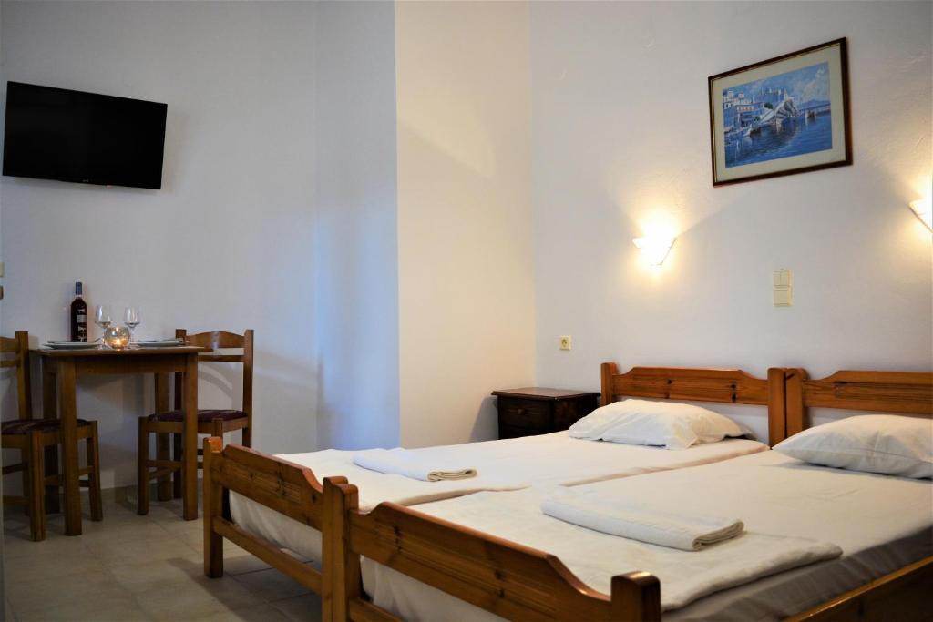A bed or beds in a room at Raph's Studios-Apts By The Sea