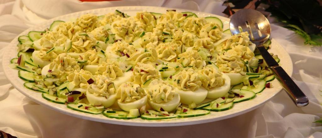 a plate of food with pasta and vegetables on a table at Young Island Resort in Kingstown