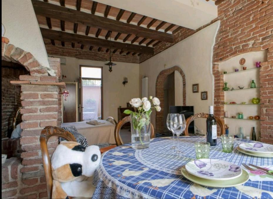 a dining room with a table with a teddy bear on it at Taverna rustica in Toscana in Fucecchio