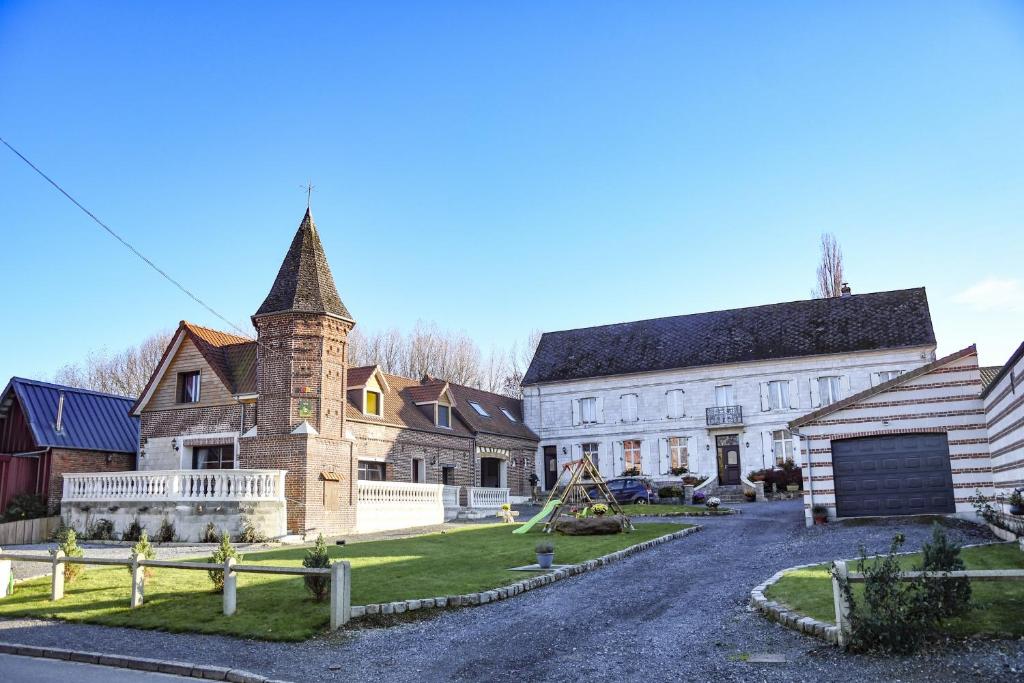 an old house with a turret on a street at La Tourelle - Gîte de charme entre Arras et Albert in Souastre