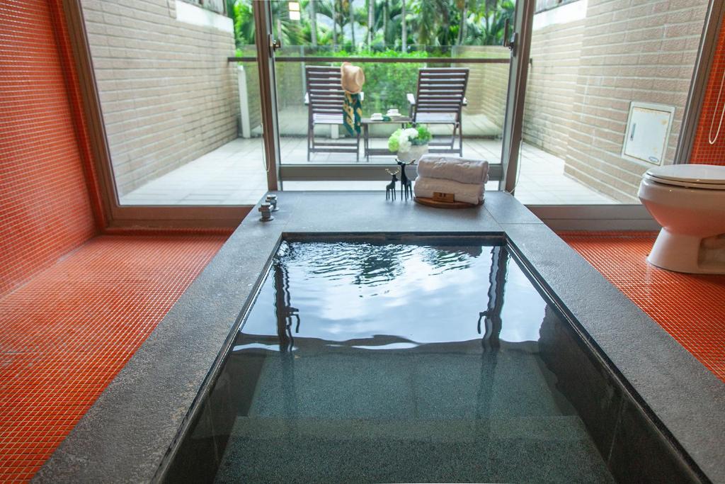 a pool of water in a room with a toilet at Luminous Hot Spring Resort &amp; SPA in Luye