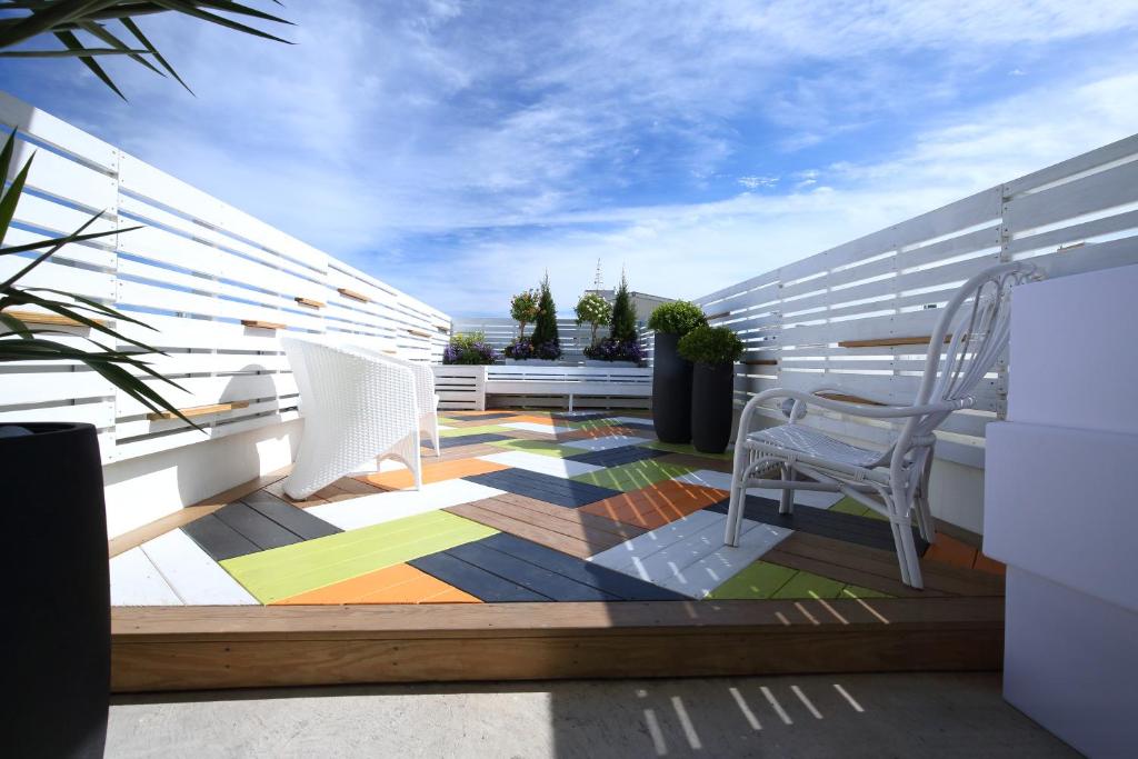 a balcony with chairs and a colorful floor at 321 Apartment B&B in Hualien City