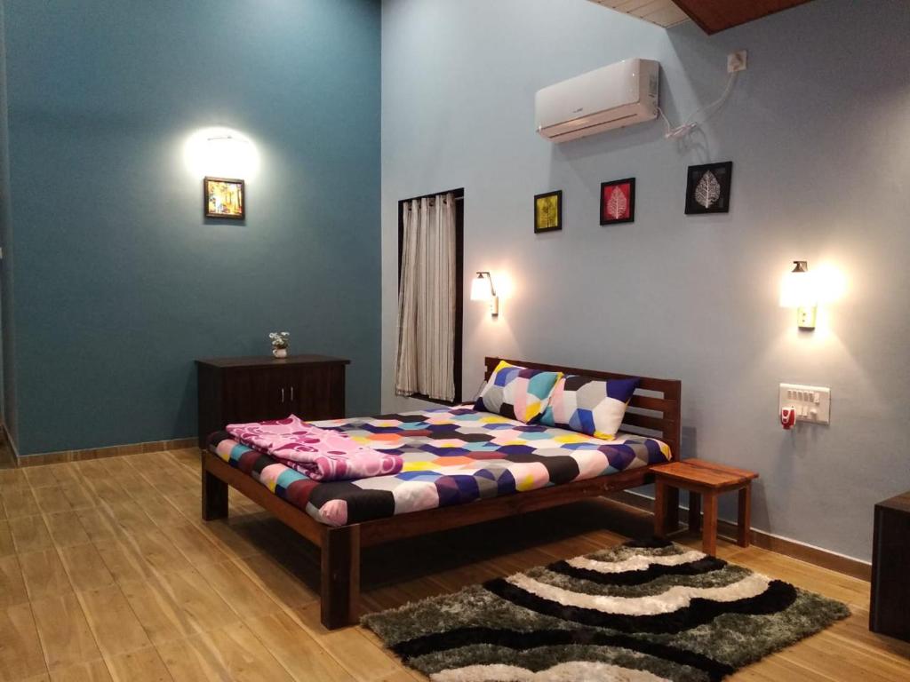 a bedroom with a bed in a room at Rutu Enclave in Murud