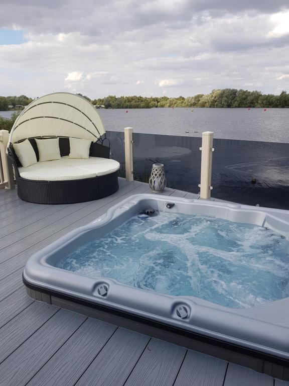 a jacuzzi tub on the deck of a boat at Dees hot tub breaks at Tattershall Lakes Jet Ski 4 in Tattershall