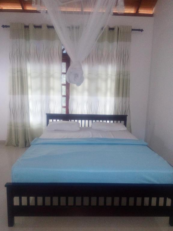 Postel nebo postele na pokoji v ubytování Sudumal Cottage