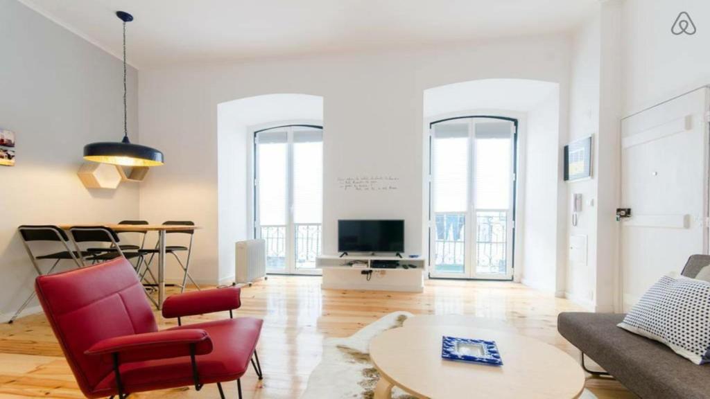 a living room with a couch and a table at Alfama Charm Apartment in Lisbon