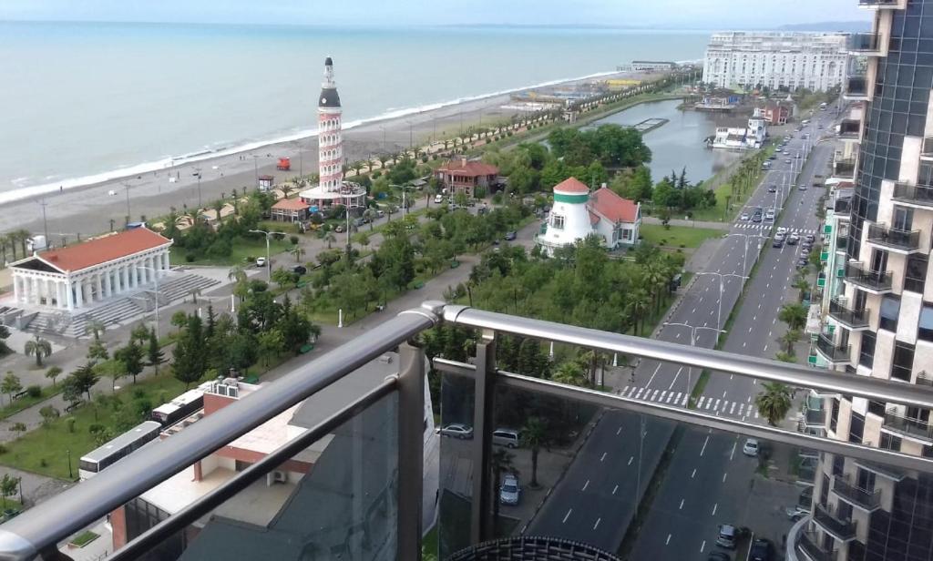 a view of the beach from the balcony of a building at Lux Apartment in Batumi