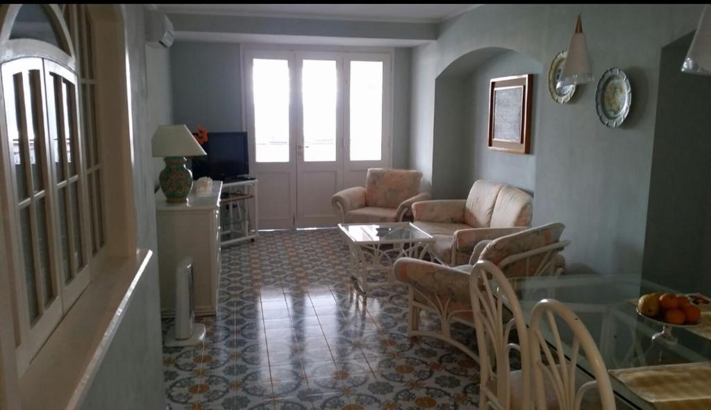 a living room with a table and chairs at La Maison de Leo in Massa Lubrense
