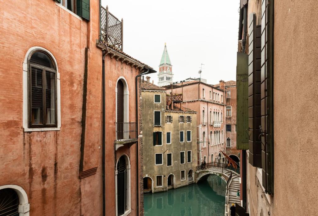 a view of a canal in a city with buildings at Luxury Venetian Rooms in Venice