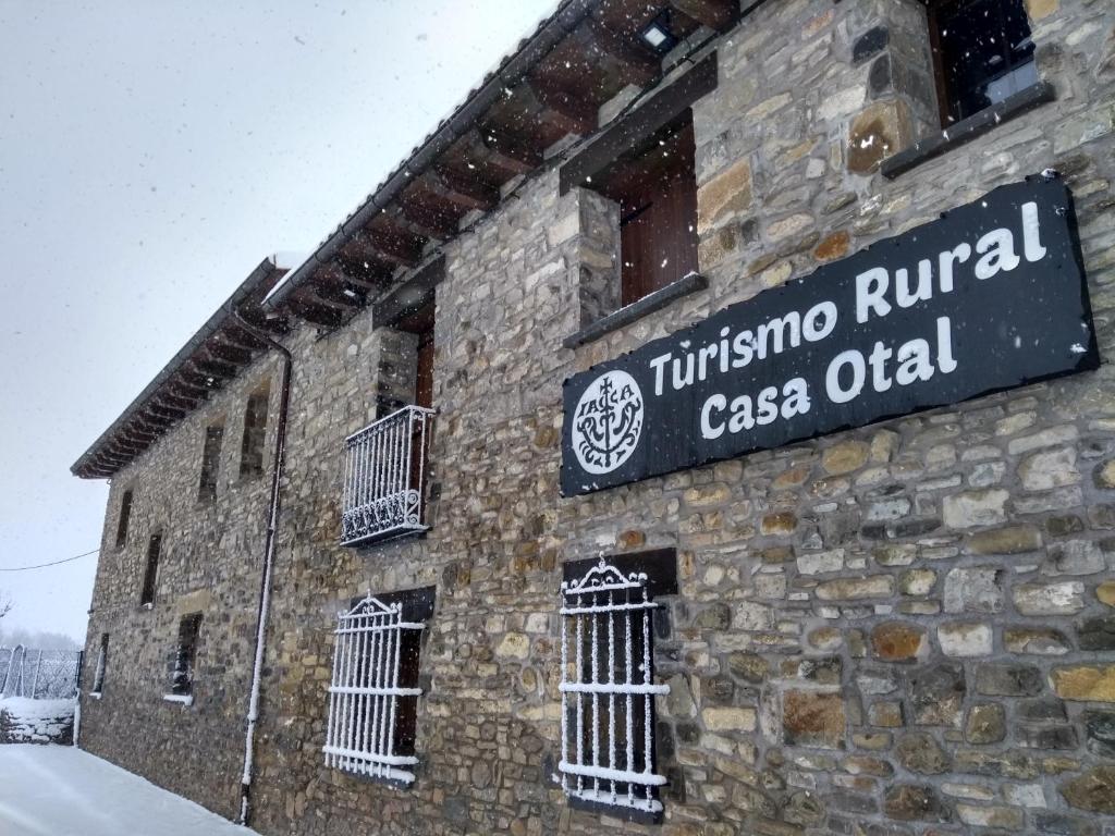 a brick building with a sign on the side of it at Casa Otal in Jaca