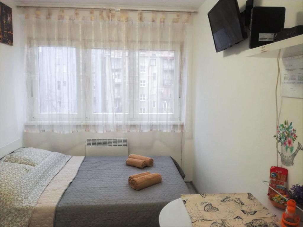 a bedroom with a bed with two pillows on it at Ruby room in Zagreb