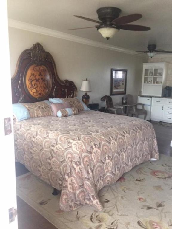 a bedroom with a large bed and a living room at Beachcomber Inn in Pismo Beach