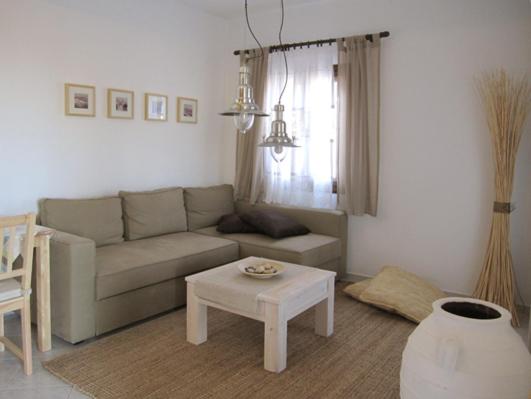 a living room with a couch and a table at Ariston Apartments in Serifos Chora
