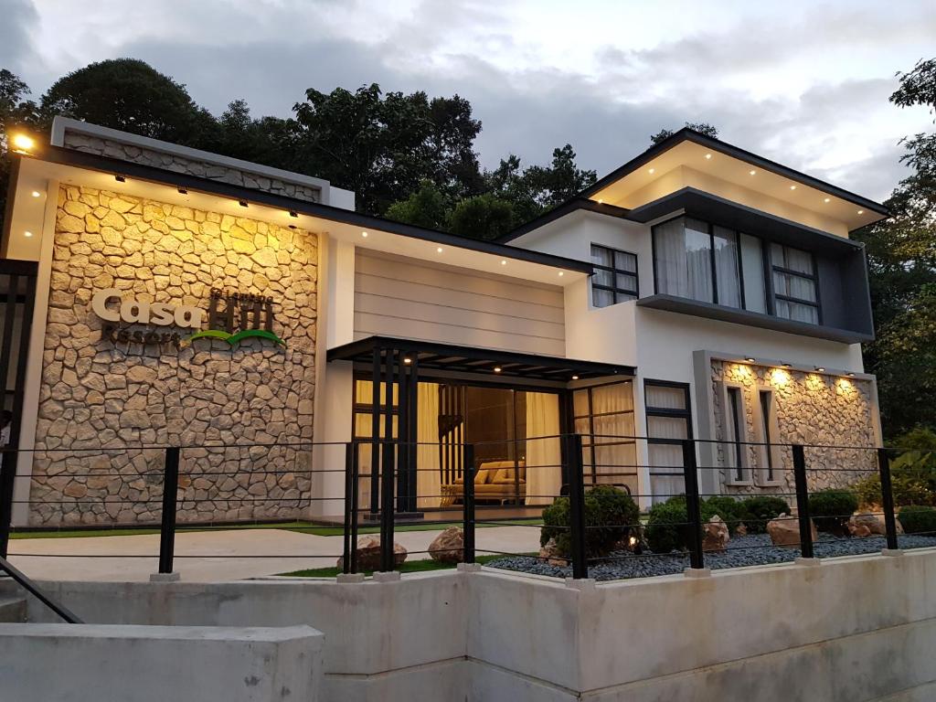 a house with a stone facade with lights on it at Casa Hill Resort in Sungai Lembing