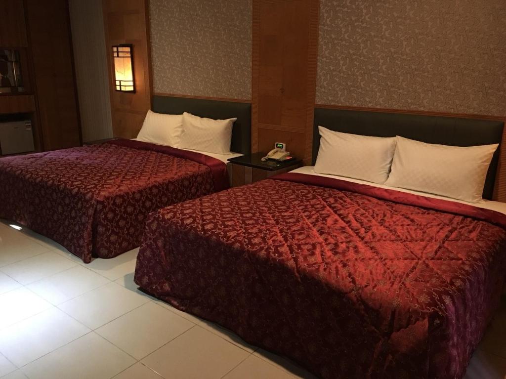 Postel nebo postele na pokoji v ubytování Wen Mei Motel