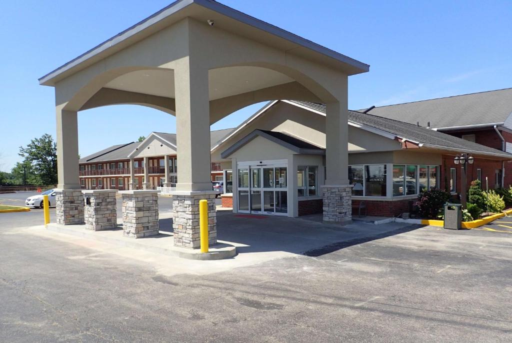 a building with a large arch in a parking lot at Baymont by Wyndham Effingham in Effingham