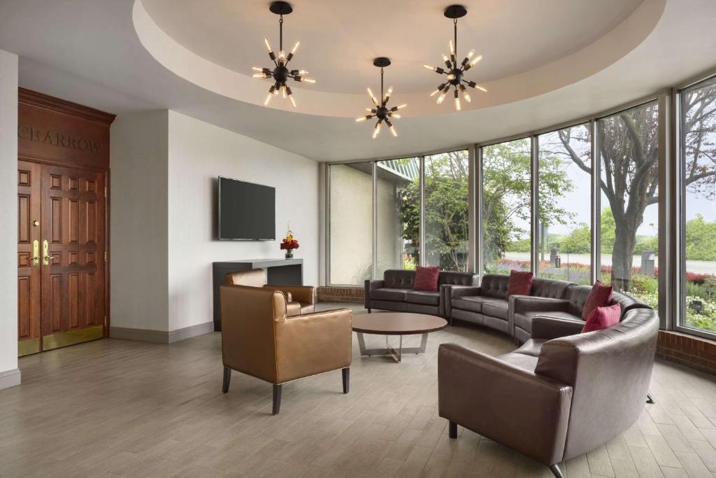 a living room with couches and a table at Ramada by Wyndham Beaver Falls in Beaver Falls