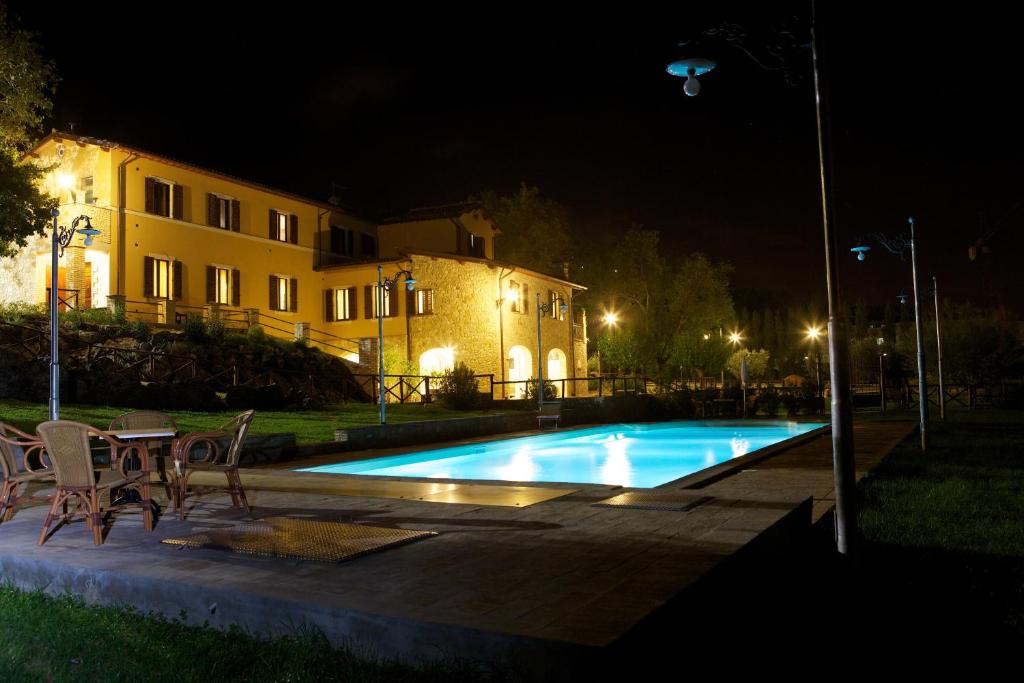 a swimming pool in front of a building at night at Casa Vacanze Residenza Bocci in Foligno