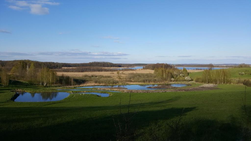 a view of a golf course with two ponds at Wyskok 1 - dom z widokiem in Srokowo