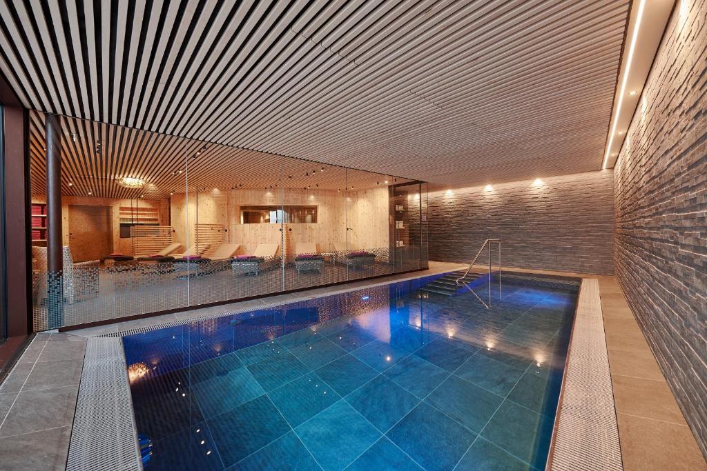 a large swimming pool in a building with at Hotel Appartement Roggal in Lech am Arlberg