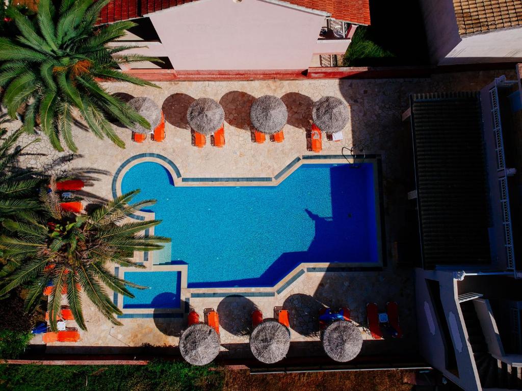 an aerial view of a swimming pool next to a house at Lena Studios in Sidari