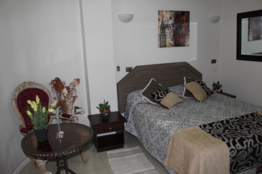 Postel nebo postele na pokoji v ubytování Hostal Quinta Normal