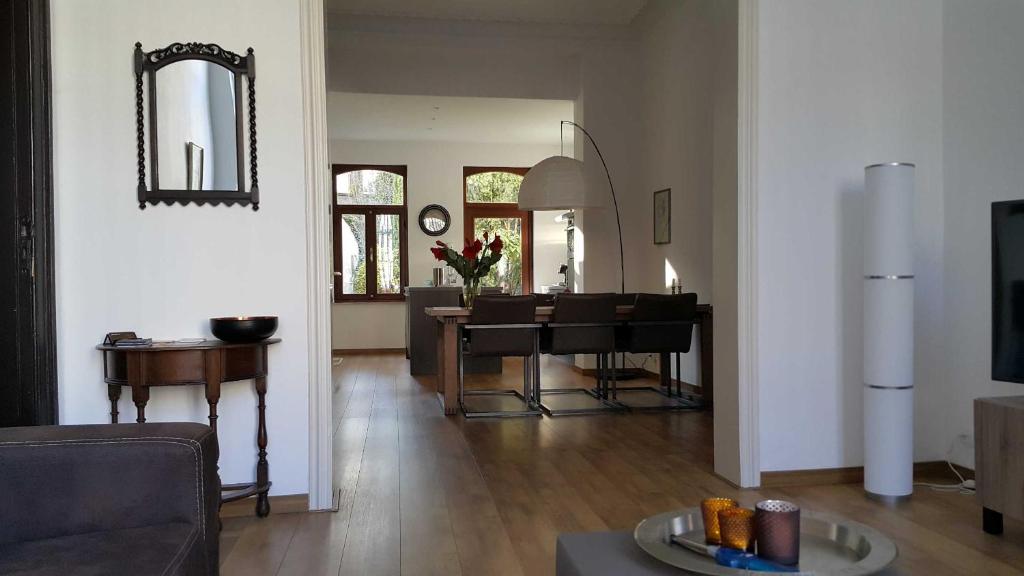 a living room with a table and a dining room at Mansion 6 in Maastricht