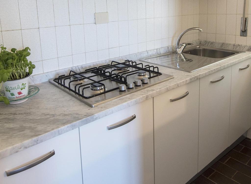 a kitchen counter with a stove and a sink at Residence Capobianco in Portoferraio