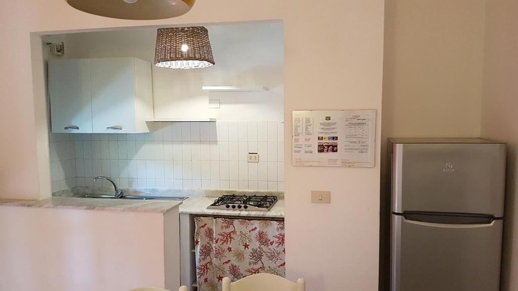a kitchen with a stove and a refrigerator at Residence Capobianco in Portoferraio