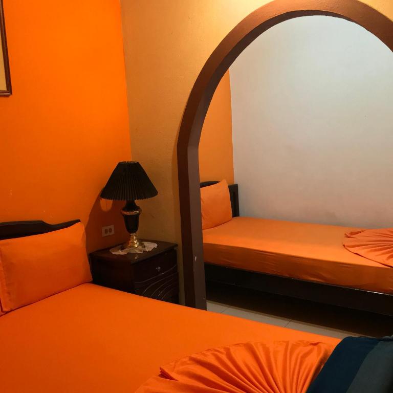 Postel nebo postele na pokoji v ubytování Hostal Puerto Azul