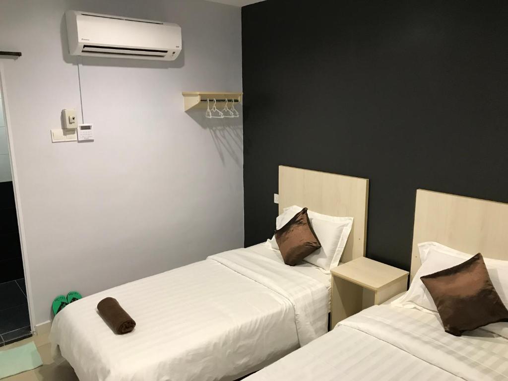 Postel nebo postele na pokoji v ubytování Hotel dan Restoran Seri Kangsar