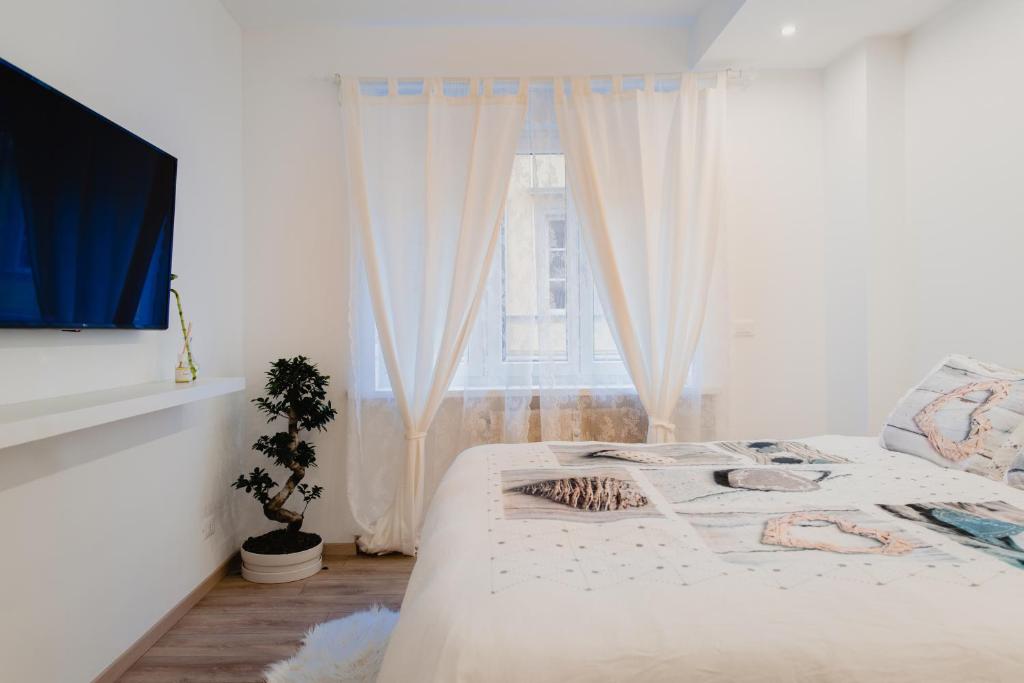 A bed or beds in a room at La Boutique del Vento - Esclusivo in pieno centro