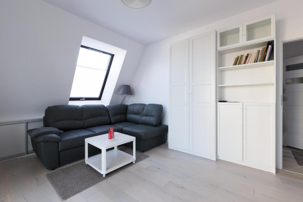 a living room with a couch and a table at Apartament przy sopockiej plaży in Sopot