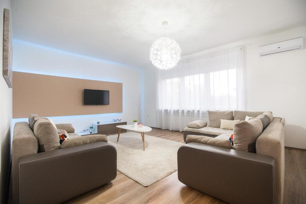 a living room with two couches and a table at Friday Apartments in Zagreb