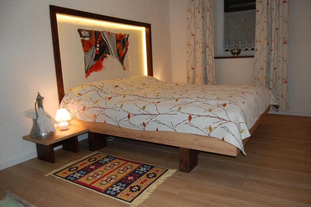 a bedroom with a bed and a lamp and a rug at Welcome in Sarajevo