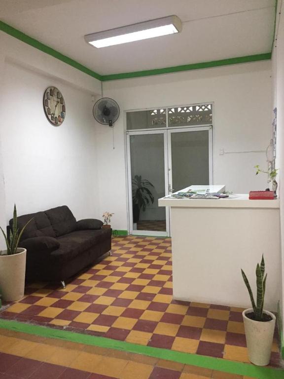a living room with a couch and a counter at Hostal La Concordia in Ciudad Valles