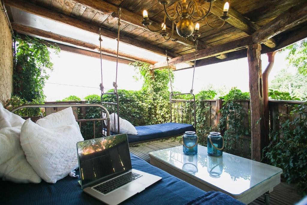 a laptop computer sitting on a table on a porch at MŁYN Z PASJĄ in Gąski