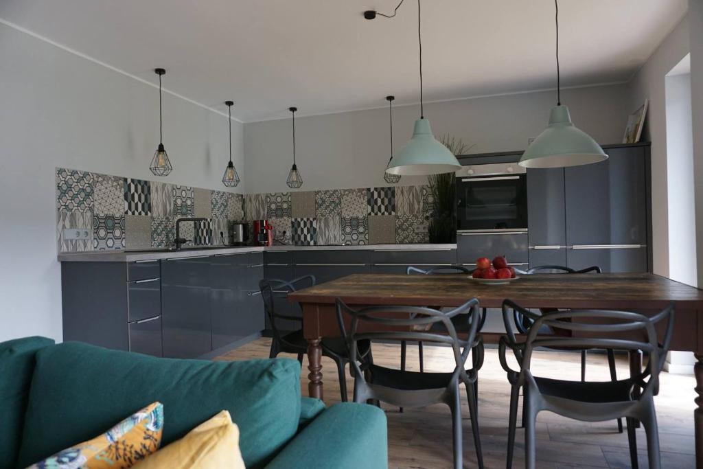 a kitchen and dining room with a table and chairs at Honiggarten in Dahn