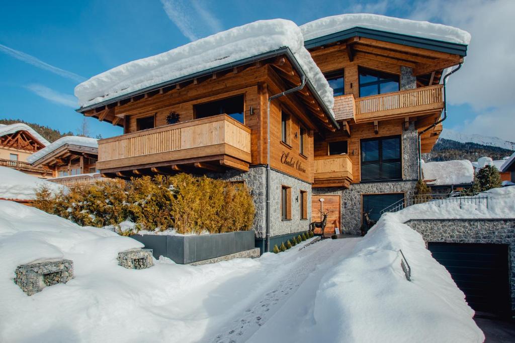 a log cabin in the snow with a garage at Chalet Olivia in Seefeld in Tirol
