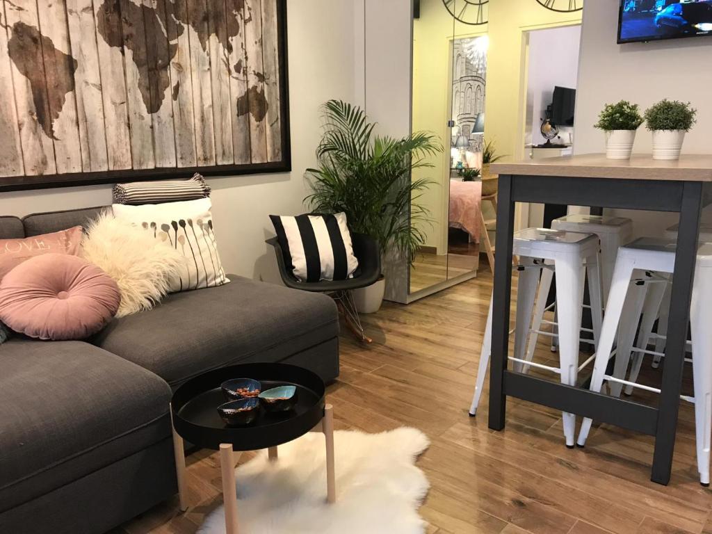 a living room with a couch and a table at Arena Design Apartments with FREE Private Parking and with a terrace in Pula