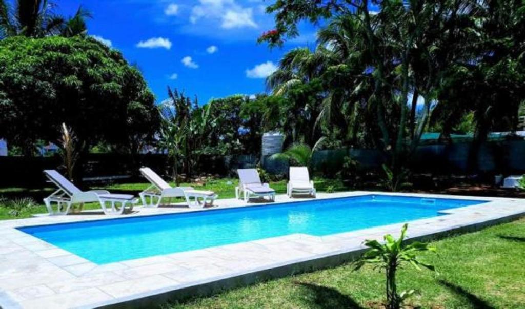 a swimming pool with lounge chairs and a swimming pool at Villa Cococherie in Poste Lafayette