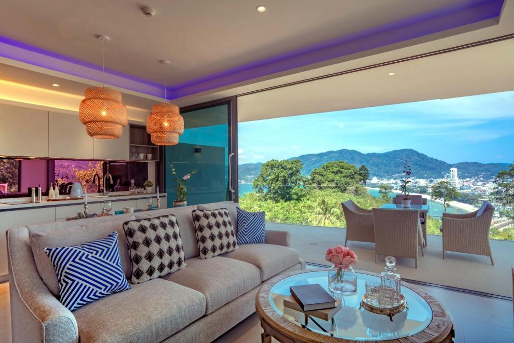 a living room with a couch and a table at Patong Heights in Patong Beach
