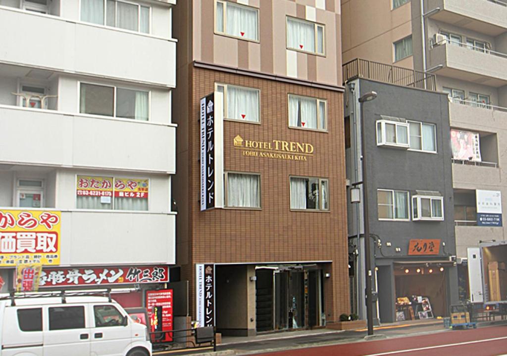 a building with a car parked in front of it at Hotel Trend Tobu Asakusa-Eki Kita in Tokyo