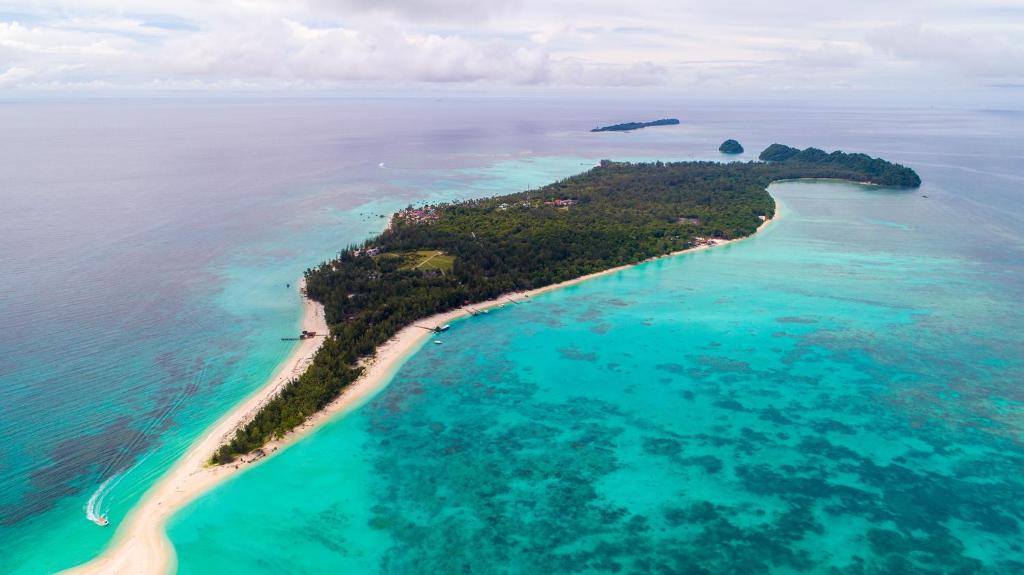 an aerial view of a beach with a large body of water at Sutera @ Mantanani Island Resort & Spa in Mantanani Island